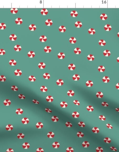 Peppermint Swirls in Red and White Scattered Randomly on on Green Fabric