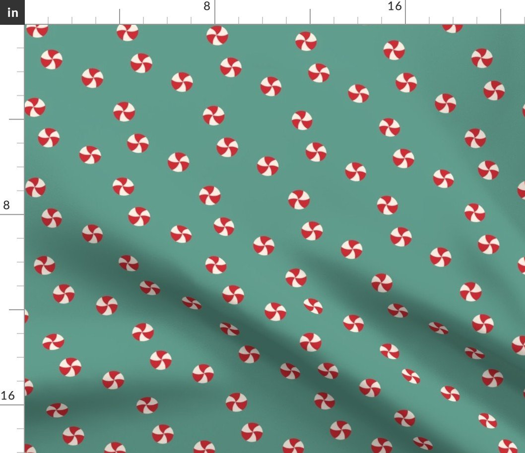 Peppermint Swirls in Red and White Scattered Randomly on on Green Fabric Peppermint Swirls in Red and White Scattered Randomly on on Green Fabric