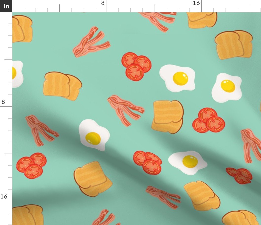 Small English Cooked Breakfast Bacon, Eggs, Tomato and Toast on Green Fabric