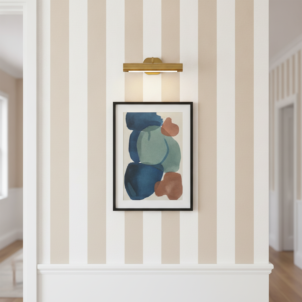 Modern white hallway feature wall with Classic 2 Inch Natural and White Modern Cabana Upholstery Stripes wallpaper and a brushed brass picture light.
