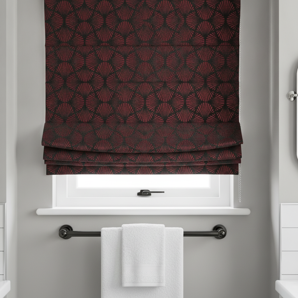 Tailored Roman blinds made from black and ruby red Art Deco fan pattern fabric, with a polished black nickel towel rail below.